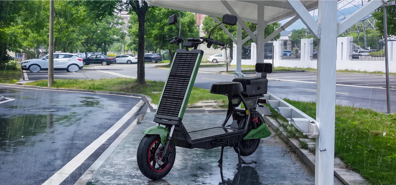 The green Laineng L101 solar electric moped parked under a shelter on a rainy day